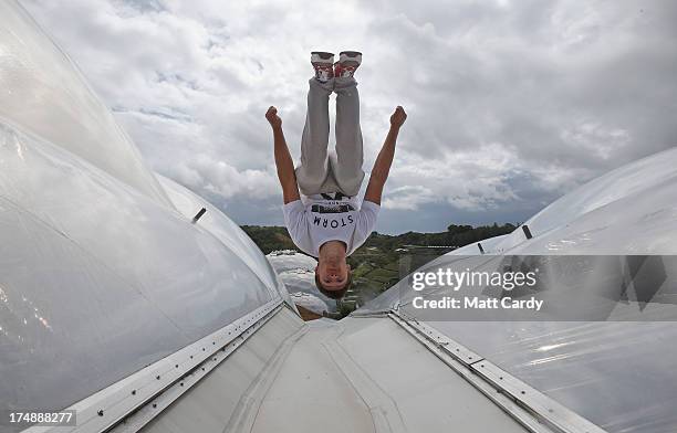 Pip Andersen professional freerunner and parkour expert somersaults on the roof of the Eden's Rainforest Biome on July 29, 2013 in St Austell,...