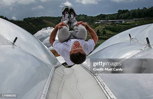 Pip Andersen professional freerunner and parkour expert somersaults on the roof of the Eden's Rainforest Biome on July 29, 2013 in St Austell,...