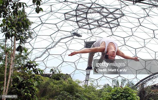 Tim Sheiff, professional freerunner and parkour expert somersaults inside the Eden Project's Rainforest Biome on July 29, 2013 in St Austell,...