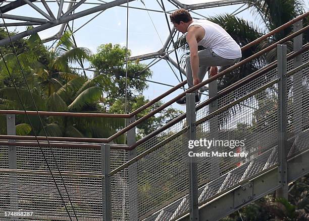 Tim Sheiff, professional freerunner and parkour expert jumps a flight of stairs inside the Eden Project's Rainforest Biome on July 29, 2013 in St...