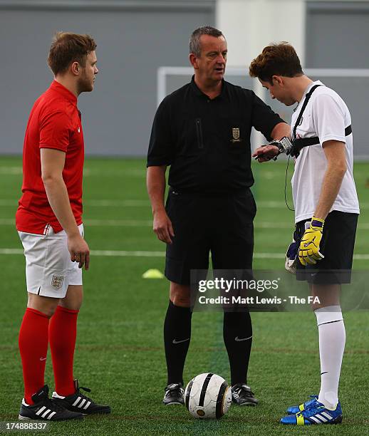 The referee speaks to Nick Grimshaw and Olly Murs before the start of the BBC Radio 1 five-a-side football match between Team Grimshaw, captained by...