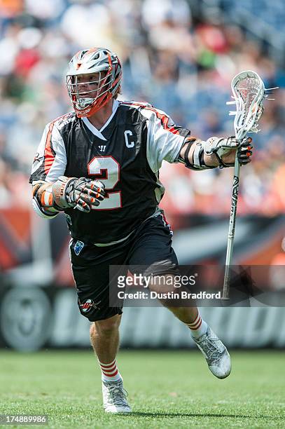 Brendan Mundorf of the Denver Outlaws runs the ball against the Chesapeake Bayhawks during a Major League Lacrosse game at Sports Authority Field at...