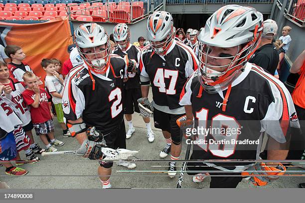 Denver Outlaws captains, from left, Brendan Mundorf, Anthony Kelly, and Jesse Schwartzman prepare to run out on the field before a game against the...