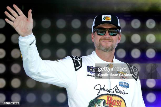 Dale Earnhardt Jr., driver of the Bass Pro Shops/Tracker Boats Chevrolet, waves to fans as he walks onstage during driver intros prior to the NASCAR...