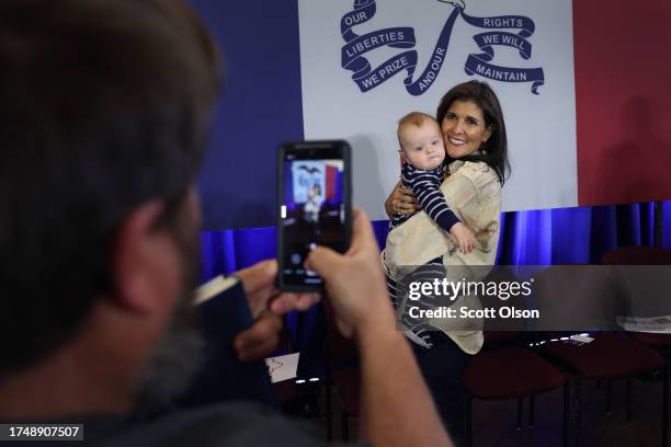 Tom Sherbondi takes a picture as Republican presidential candidate former U.N. Ambassador Nikki Haley with his son Sawyer during a campaign event...