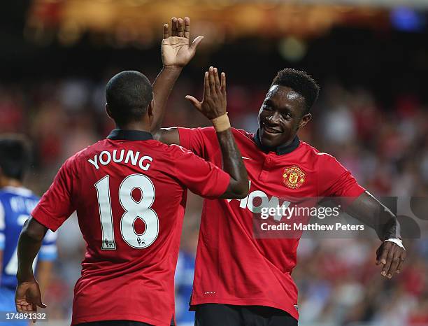 Danny Welbeck of Manchester United celebrates scoring ther first goal with Ashley Young during the pre-season friendly match between Kitchee FC and...