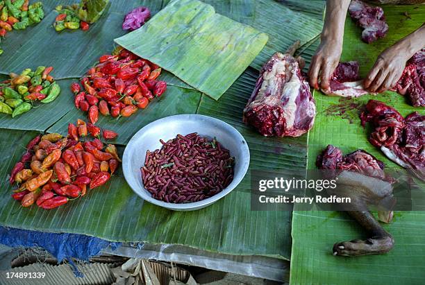 At left, fresh Bhut Jolokia chilies, also known as Raja Chilies, for sale at the main market in Kohima, the capital of Nagaland. In the center is a...