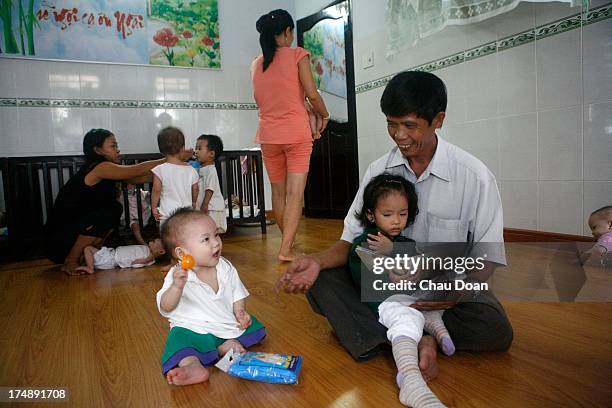 Tong Phuoc Phuc, aged 45, at his orphanage in Nha Trang where he raises 24 abandoned babies. Phuc has second home where he raises another 30 babies...