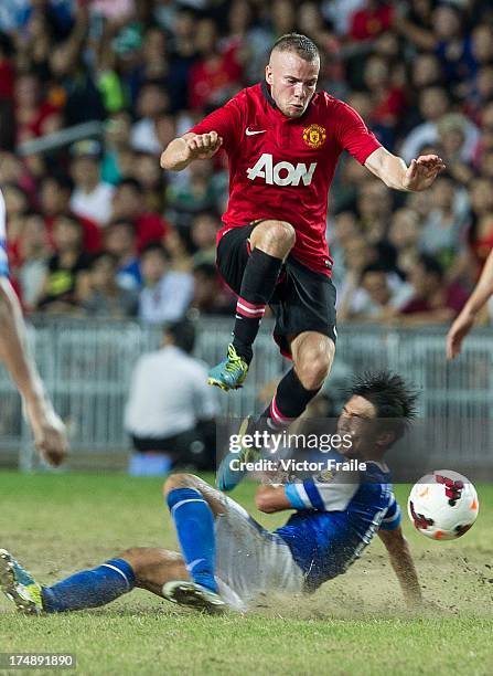 Tom Cleverley of Manchester United and Huang Yang of Kitchee FC fight for the ball during the international friendly match between Kitchee FC and...