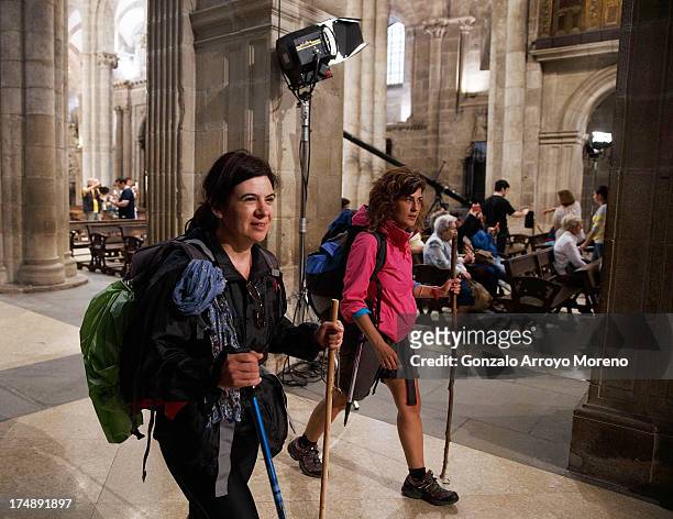 Pilgrims walks inside Santiago de Compostela Cathedral, where a memorial mass will be held for the victims of a train crash July 29, 2013 in Santiago...
