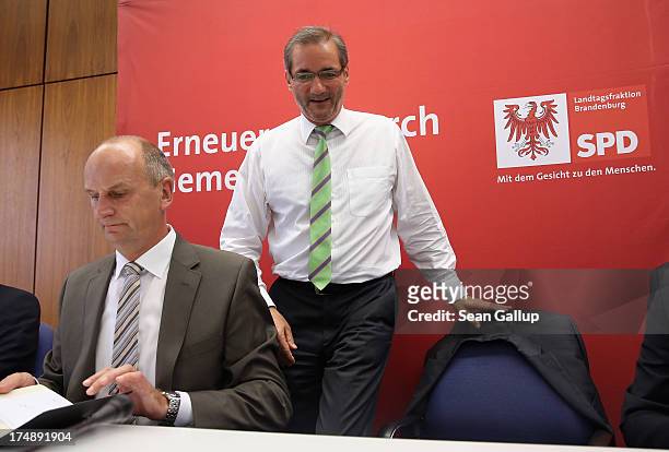 Brandenburg Governor and German Social Democrat Matthias Platzeck sits down next to Brandenburg State Minister of the Interior Dietmar Woidke upon...