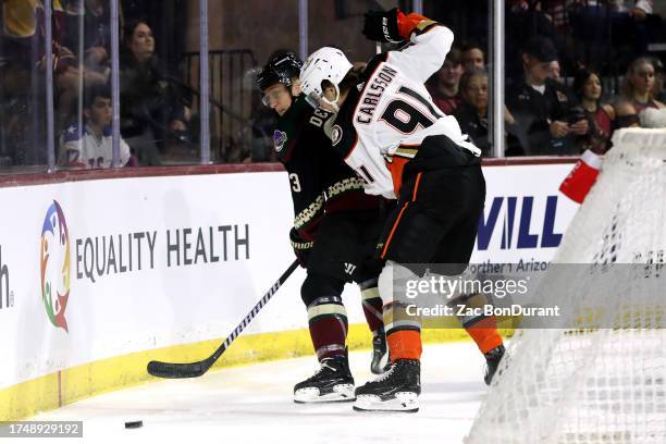 Travis Dermott of the Arizona Coyotes makes a pass against Leo Carlsson of the Anaheim Ducks during the first period at Mullett Arena on October 21,...