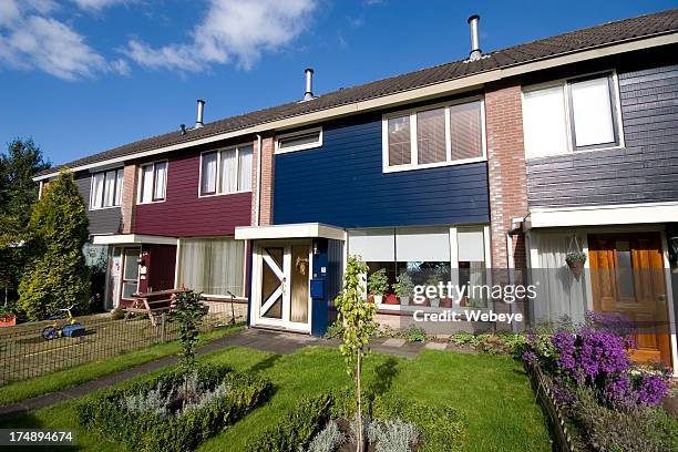 exterior view of multicolored dutch homes connected together - nederland stockfoto's en -beelden