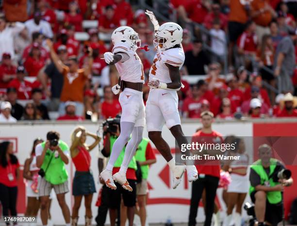 Baxter of the Texas Longhorns celebrates with Xavier Worthy of the Texas Longhorns after a touchdown in the first quarter against the Houston Cougars...