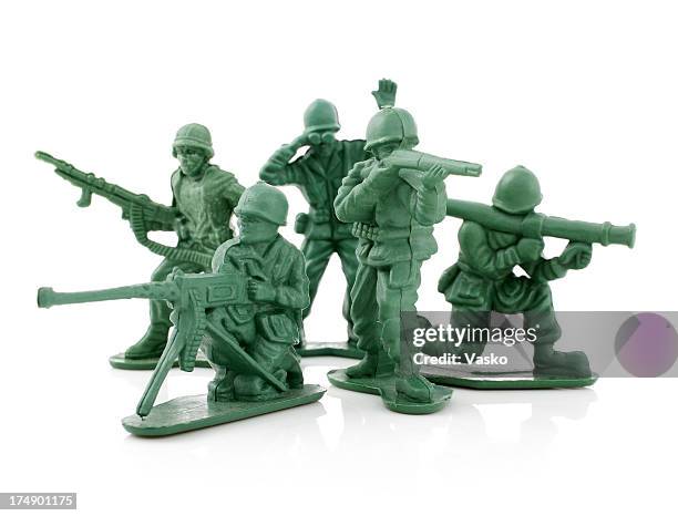 four isolated toy soldiers on a white background - plastic toy stock pictures, royalty-free photos & images