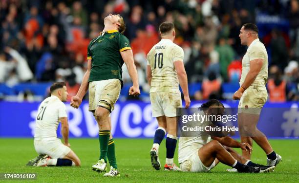 Pieter-Steph Du Toit of South Africa celebrates as England players look dejected after the final whistle during the Rugby World Cup France 2023 match...