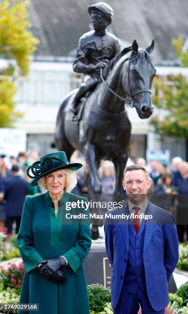 Frankie Dettori and Queen Camilla stand next to a newly unveiled statue of Frankie as they attend QIPCO British Champions Day at Ascot Racecourse on...