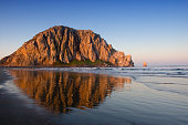 Image of Morro Rock and its reflection in water