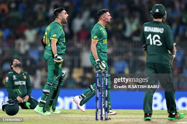 South Africa's Tabraiz Shamsi and Keshav Maharaj celebrate after their win at the end of the 2023 ICC Men's Cricket World Cup one-day international...