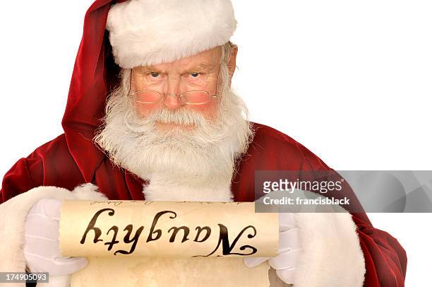santa looking at naughty list - liste stock pictures, royalty-free photos & images