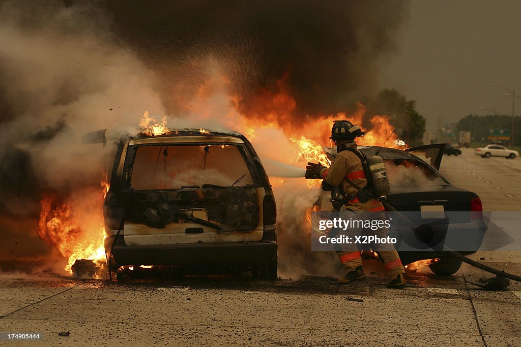 Tampa Firefighter puts out a car fire