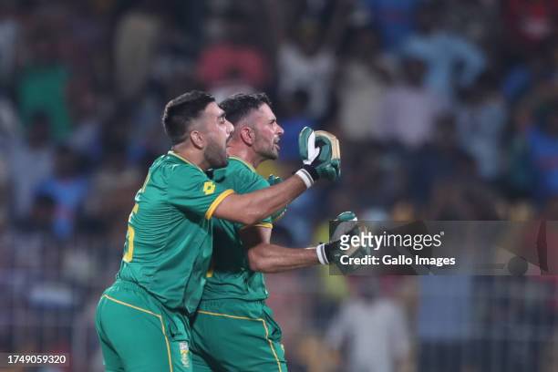 Keshav Maharaj and Tabraiz Shamsi of South Africa celebrate their victory during the ICC Men's Cricket World Cup 2023 match between South Africa and...