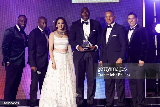 Sol Campbell receives the 'Sporting Equals Lifetime Achievement Award' presented by Axel Blake, Seema Jaswal, Densign White and Arun Kang onstage...