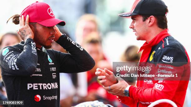 Second placed Lewis Hamilton of Great Britain and Mercedes talks with Third placed Charles Leclerc of Monaco and Ferrari in parc ferme after the...