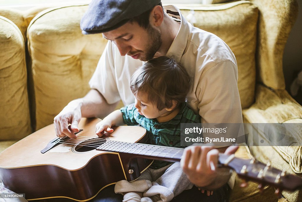 Dad Teaching Toddler to Play Instrument