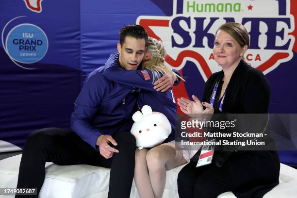Chelsea Liu and Balazs Nagy of United States celebrate in the Kiss & Cry with their coach Jenni Meno after skating in the Pairs Free Skate during the...