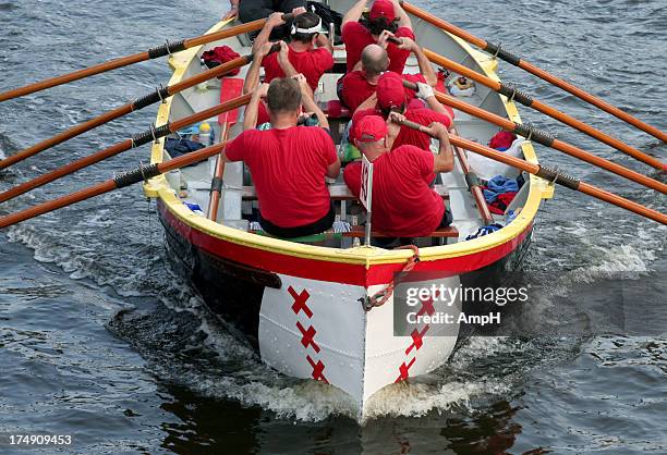 rowing a boat together - teamwork rowing stock pictures, royalty-free photos & images