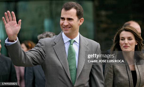 Spanish Crown Prince Felipe and Princess Letizia greet the crowd after the inauguration ceremony of the local Chamber of Commerce new building with...