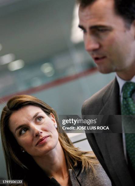 Princess Letizia looks at Spanish Crown Prince Felipe during the inauguration ceremony of the local Chamber of Commerce new building with the...