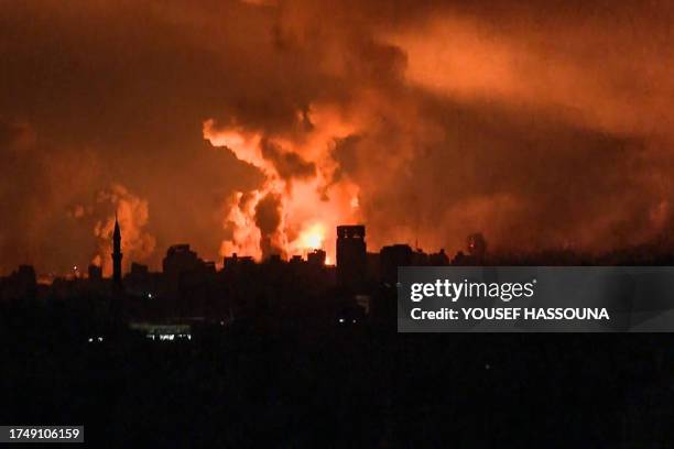 This image grab from an AFP TV footage shows balls of fire and smoke rising above Gaza City during an Israeli strike on October 27 as battles between...