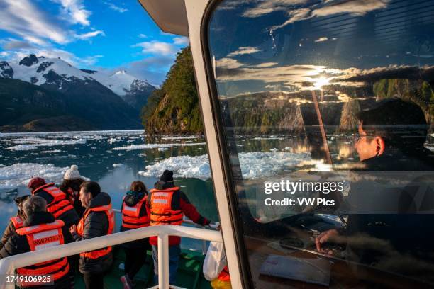Tourists at Capitan Constantino icebreaker cruise at Fjord Calvo On The Edge Of The Sarmiento Channel in Bernardo O'Higgins National Park in...