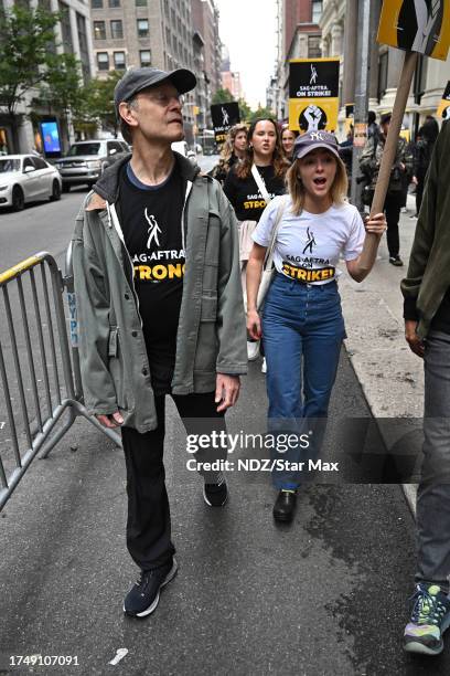 David Hyde Pierce and AnnaSophia Robb walk a picket line outside Warner Bros. Discovery Headquarters on October 27, 2023 in New York City.