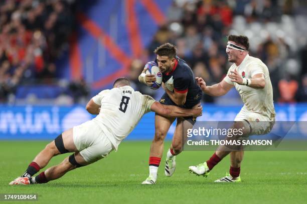 Argentina's full-back Juan Cruz Mallia attempts to break away from England's number eight Ben Earl and England's blindside flanker Tom Curry during...