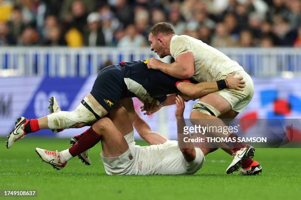 Argentina's left wing Mateo Carreras is tackled by England's openside flanker Sam Underhill and England's fly-half and captain Owen Farrell during...