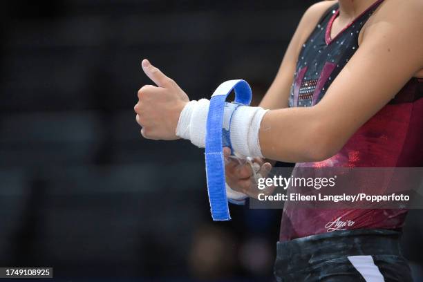 Close-up of a gymnast tightening her grips during a training session before the Les Nouveaux Internationaux De France De Gymnastique on September 15,...