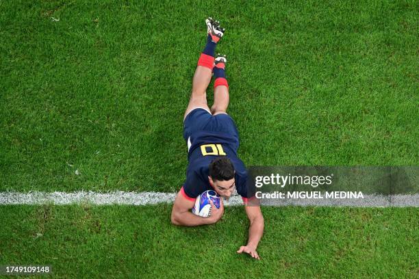 Argentina's fly-half Santiago Carreras dives across the line to score a try during the France 2023 Rugby World Cup third-place match between...