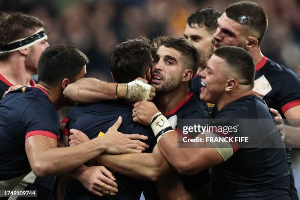 Argentina's fly-half Santiago Carreras celebrates with teammates after scoring a try during the France 2023 Rugby World Cup third-place match between...