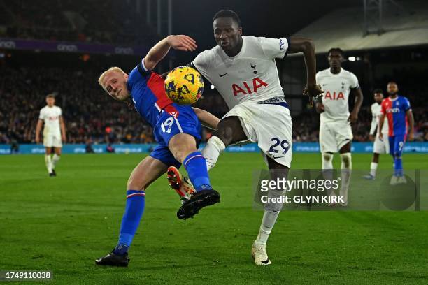 Tottenham Hotspur's Senegalese midfielder Pape Matar Sarr vies with Crystal Palace's English midfielder Will Hughes during the English Premier League...