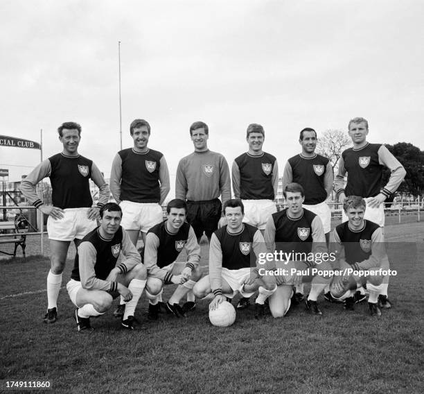 West Ham United line up for a group photo wearing their 1964 FA Cup final shirts before a pre-season friendly, circa August 1964. Back row : Ken...