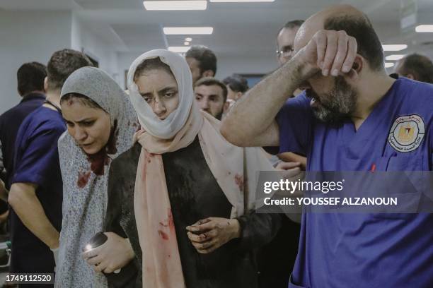 Gaza, Palestine. Injured individuals, including children, are being transported to the overwhelmed Al-Shifa Hospital in Gaza City, where doctors face...