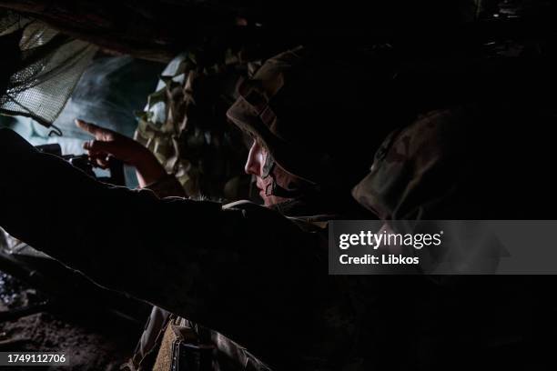 Portrait of a Ukrainian soldier in a trench after being shot at by a large-caliber machine gun on October 27, 2023 in the Bakhmut district of...