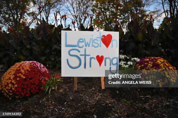 Lewiston Strong" is left by flowers in Lewiston, Maine, on October 27 in the aftermath of a mass shooting. Police in Maine struggled for a second day...