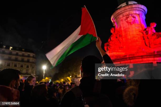 Demonstrator waves the Palestinian flag during the rally in support of Palestinian people in Gaza, at Place de la Republique in Paris, France, on...