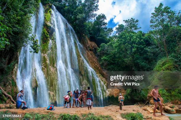 Tourists in the scenic cascade of El Limon waterfall in jungles of Samana peninsula in Dominican Republic. Amazing summer look of cascade in tropical...