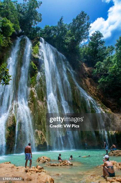 Tourists in the scenic cascade of El Limon waterfall in jungles of Samana peninsula in Dominican Republic. Amazing summer look of cascade in tropical...