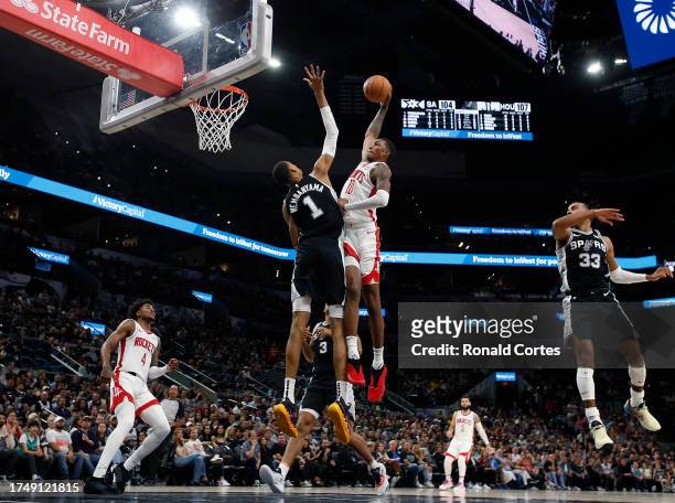 Jabari Smith Jr. #10 of the Houston Rockets tries to dunk over Victor Wembanyama of the San Antonio Spurs in the second half at Frost Bank Center on...